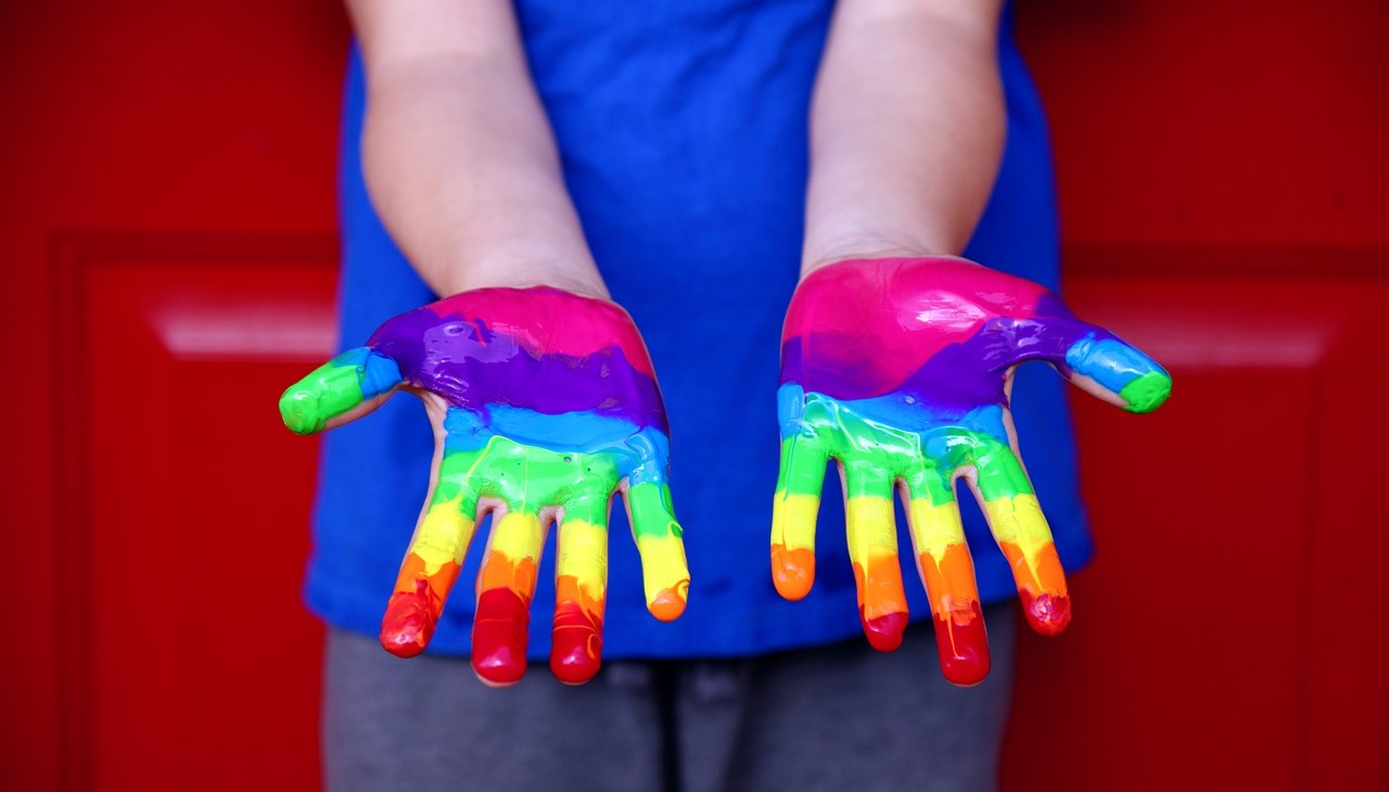 Hands painted with the rainbow colors. 