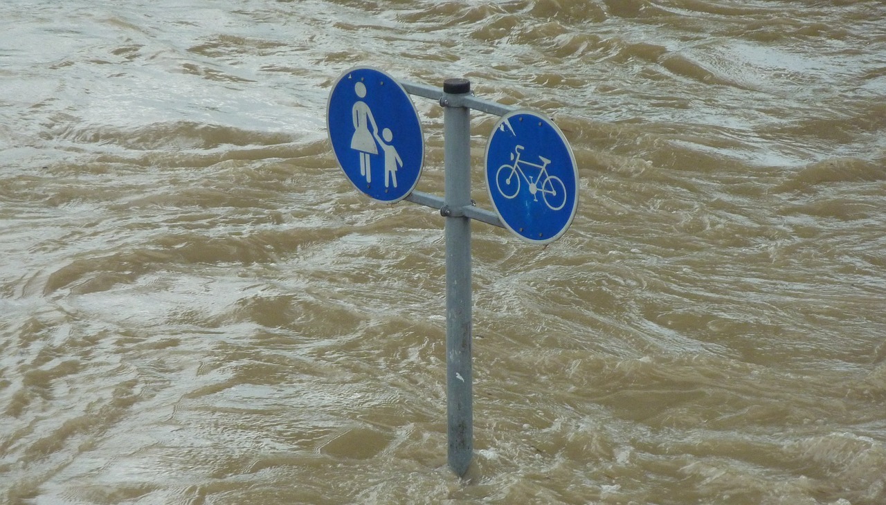 Traffic sign covered by water after a flood. 