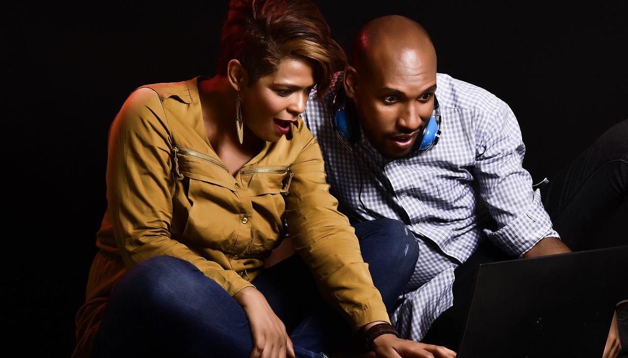 Black couple watching a video on a laptop