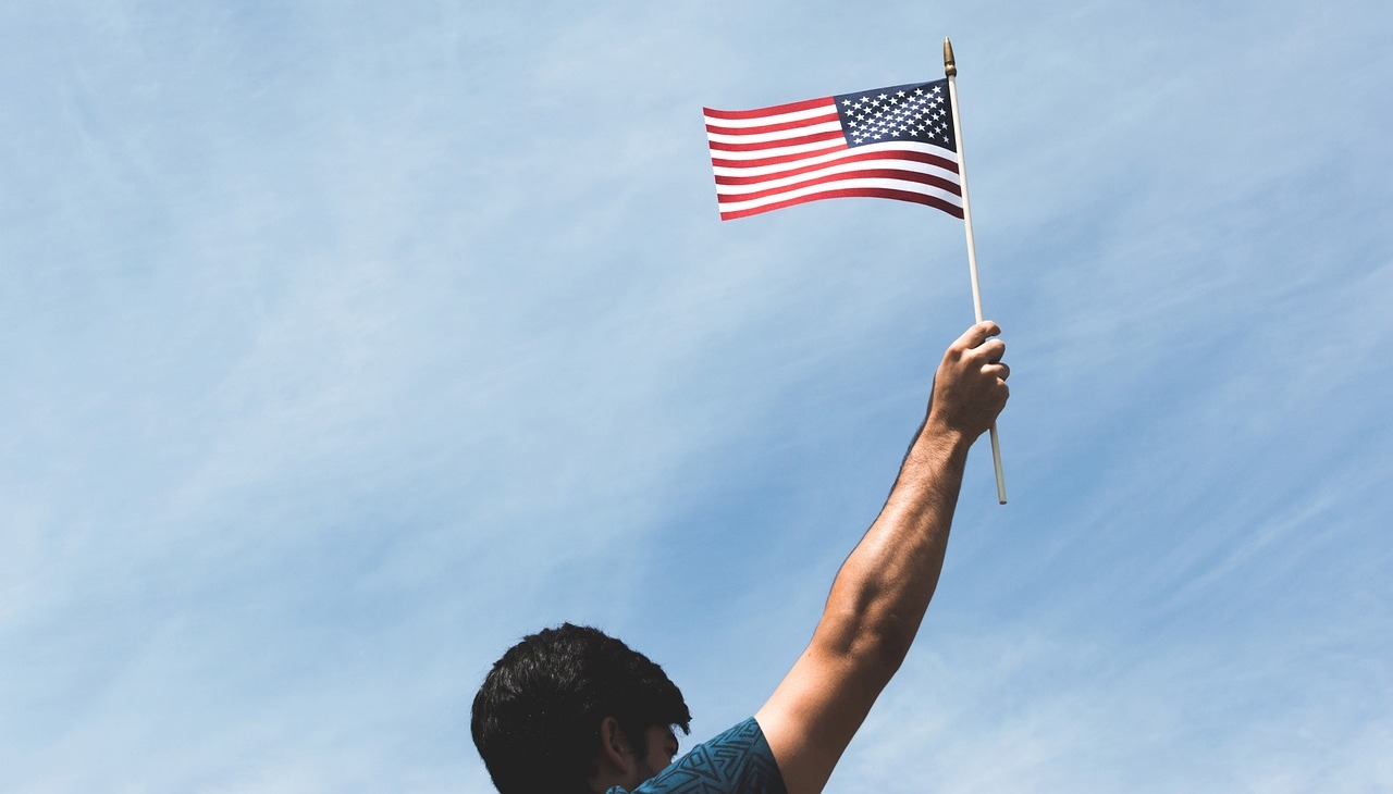 A man waves a U.S. flag. 