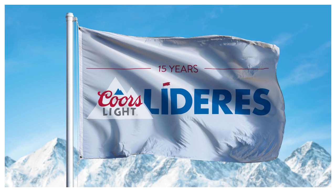 The Coors Light Líderes flag in front of a snow covered mountain.