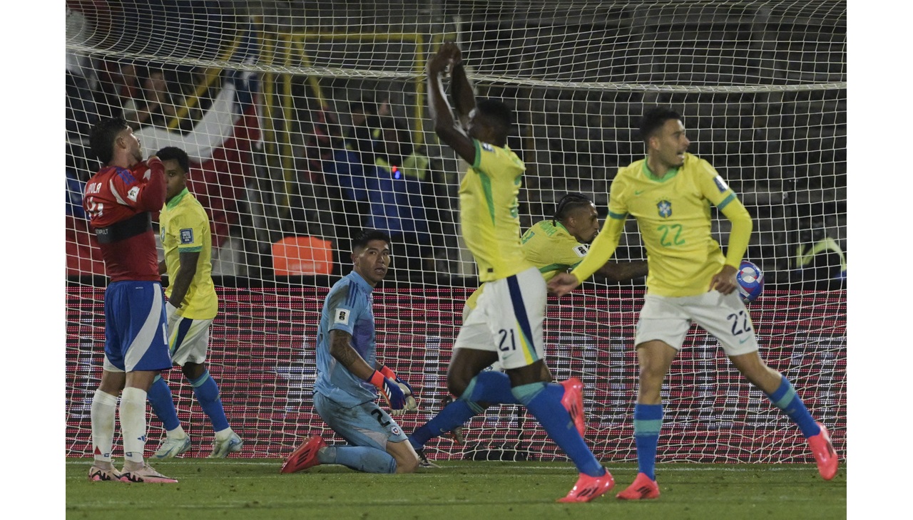 Chile's goalkeeper Brayan Cortes (3rd-L) looks at Brazil's forward Luiz Henrique (4th-L) celebrates after he scores his team's second goal during the 2026 FIFA World Cup South American qualifiers football match between Chile and Brazil, at the National stadium in Santiago, on October 10, 2024. (Photo by Rodrigo ARANGUA / AFP)