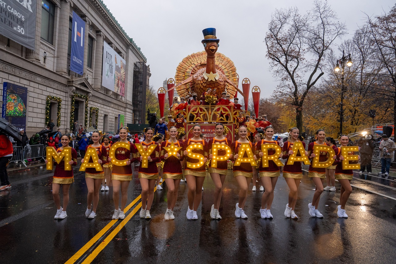 Cheerleaders perform in the rain during the annual Macy's Thanksgiving Day Parade in New York City on November 28, 2024. (Photo by David Dee Delgado / AFP)