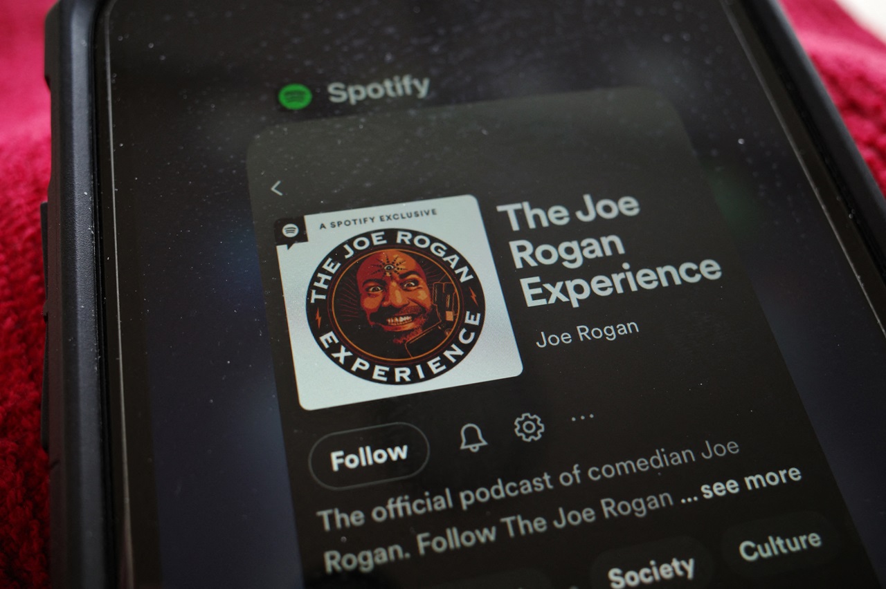 This illustration photo shows the Spotify page for "The Joe Rogan Experience" podcast displayed on a smart phone in Washington, DC on February 7, 2022. The head of music streaming giant Spotify Daniel Ek has condemned podcaster Joe Rogan's use of a racial slur but insisted that silencing him was not the answer. (Photo by MANDEL NGAN / AFP)