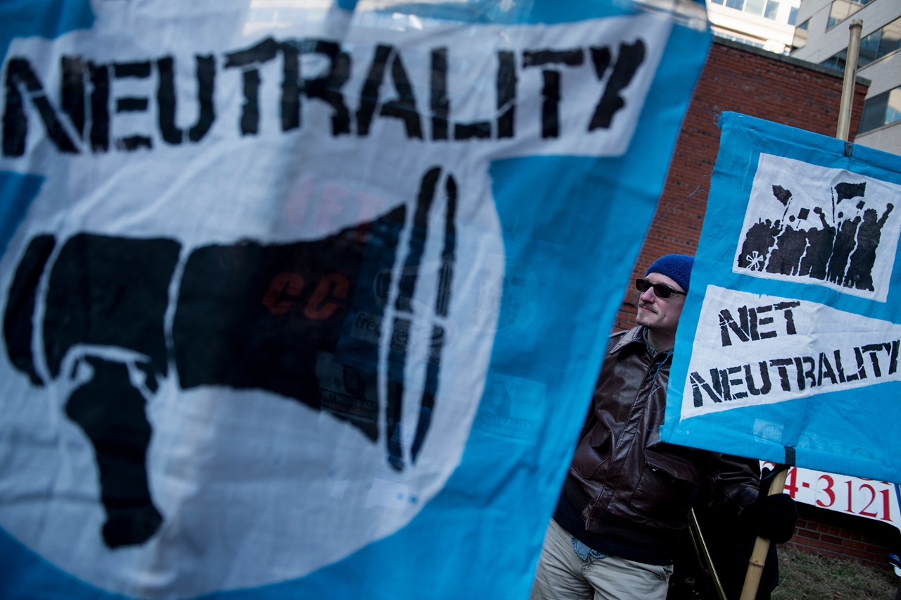 Activists gather before a hearing at the Federal Communications Commission on December 14, 2017 in Washington, DC. (Photo by Brendan Smialowski / AFP)