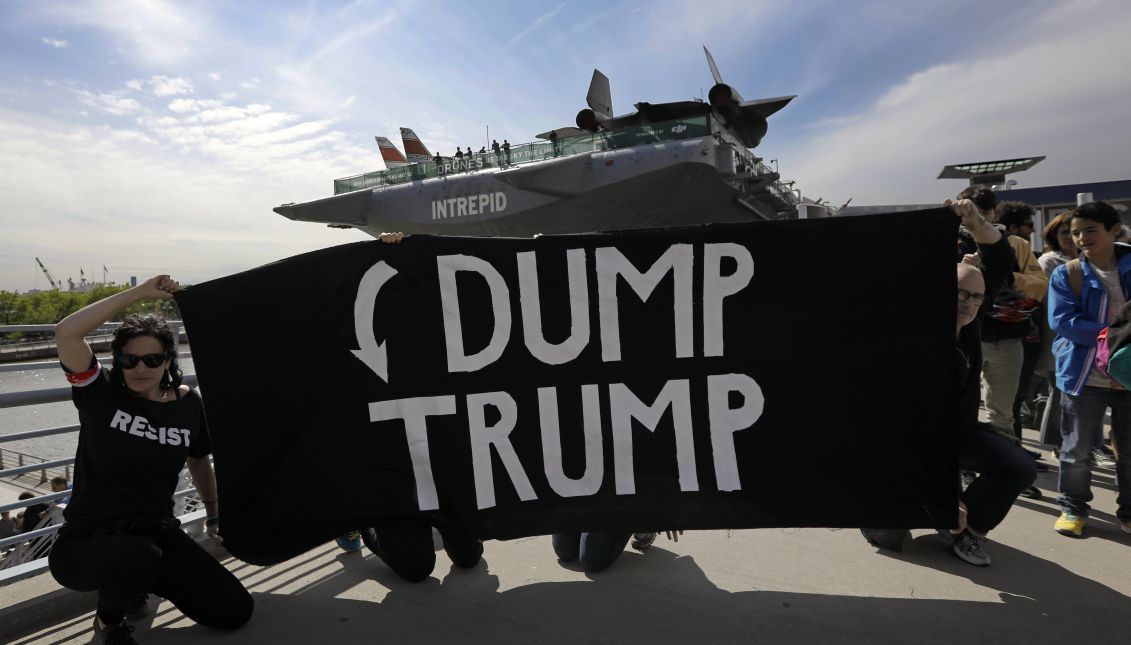 Trump protesters hold up a banner in front of the USS Intrepid where later this evening President Trump will attend a dinner with Prime Minister Malcolm Turnbull of Australia, in New York, New York, USA, 05 May 2017. EPA/PETER FOLEY
