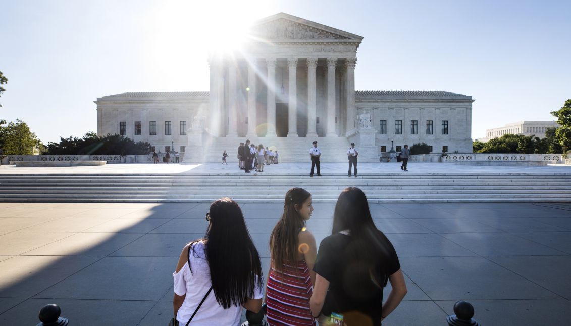People gather outside the Supreme Court where the justices are expected to deliver a much-anticipated ruling on US President Donald J. Trump's travel ban on visitors to the US from six predominantly Muslim countries in Washington, DC, USA, 26 June 2017. EPA/JIM LO SCALZO
