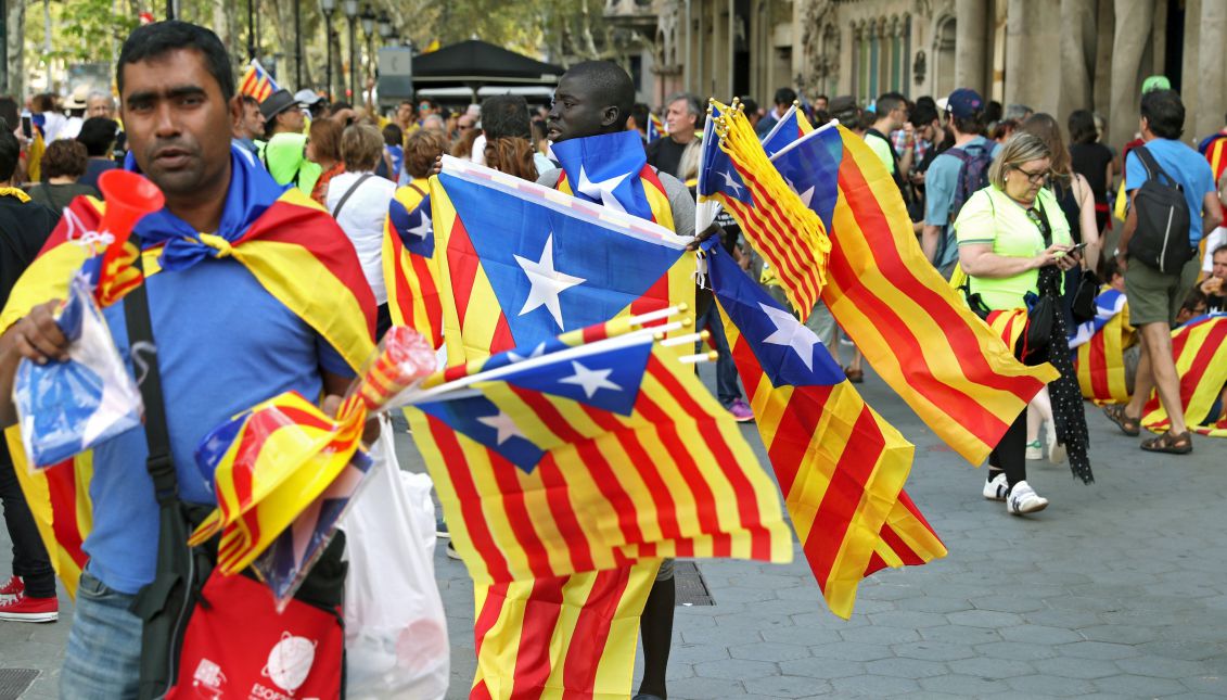 Street sellers with unofficial Catalonian flags outside Casa Batllo during the National Day of Catalonia (Diada) in Barcelona, Catalonia, Spain, Sept. 11, 2017. EPA-EFE/Toni Albir
