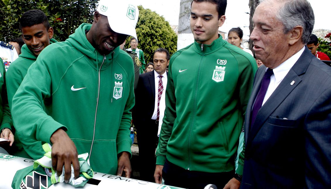Atletico Nacional players Rodin Quiñones (L) and Felipe Aguilar (C), accompanied by the club president Andres Botero (R), deposit a jersey of their team in a "time capsule" during a tribute to the victims of the Chapecoense soccer club who died in a plane crash a year ago in the municipality of La Union, Colombia, Nov. 28, 2017. EPA-EFE/LUIS EDUARDO NORIEGA A
