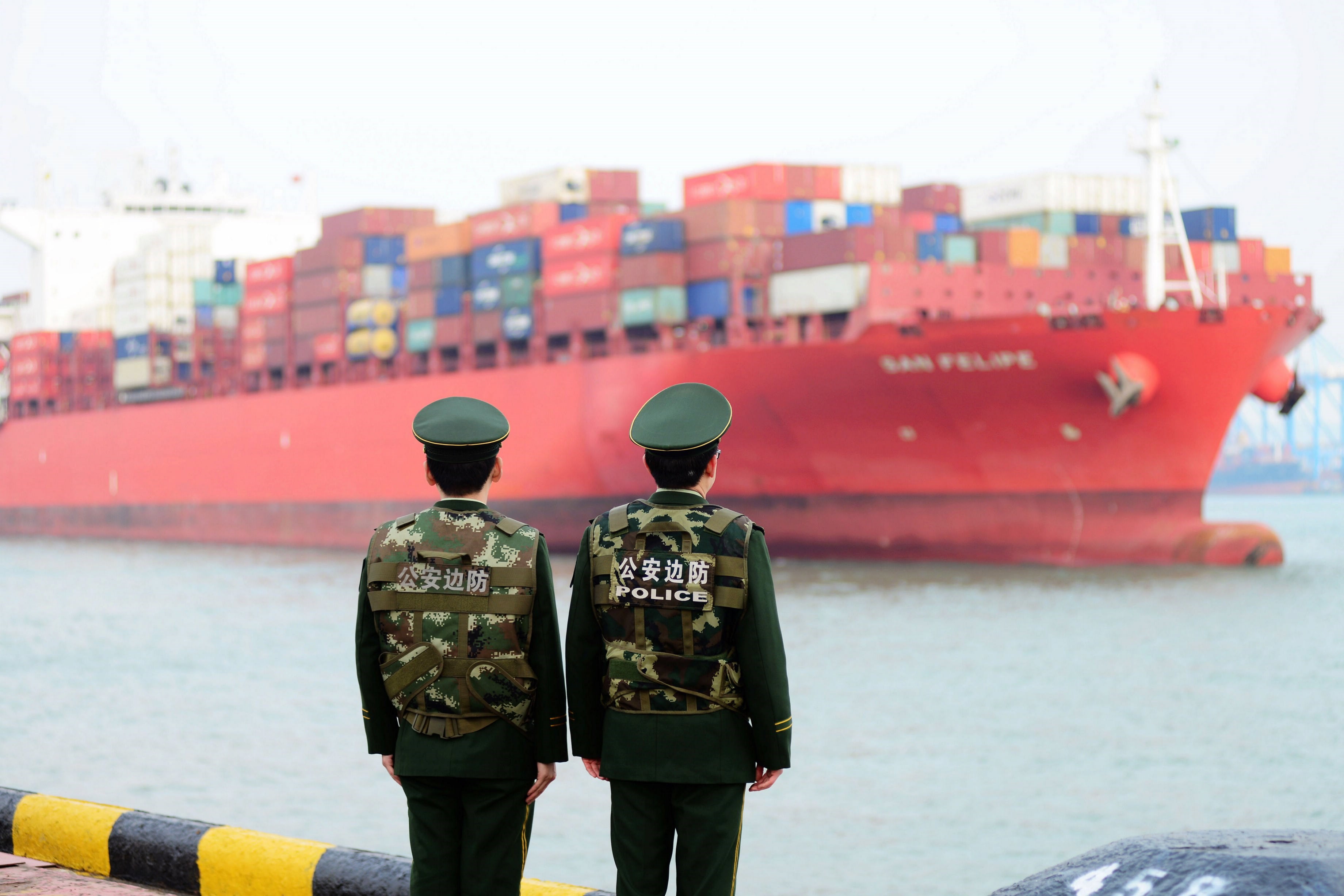 Border guards work at a container port in Qingdao, Shandong province, China, Mar. 08, 2018. EPA-EFE/FILE/YU FANGPING CHINA OUT
