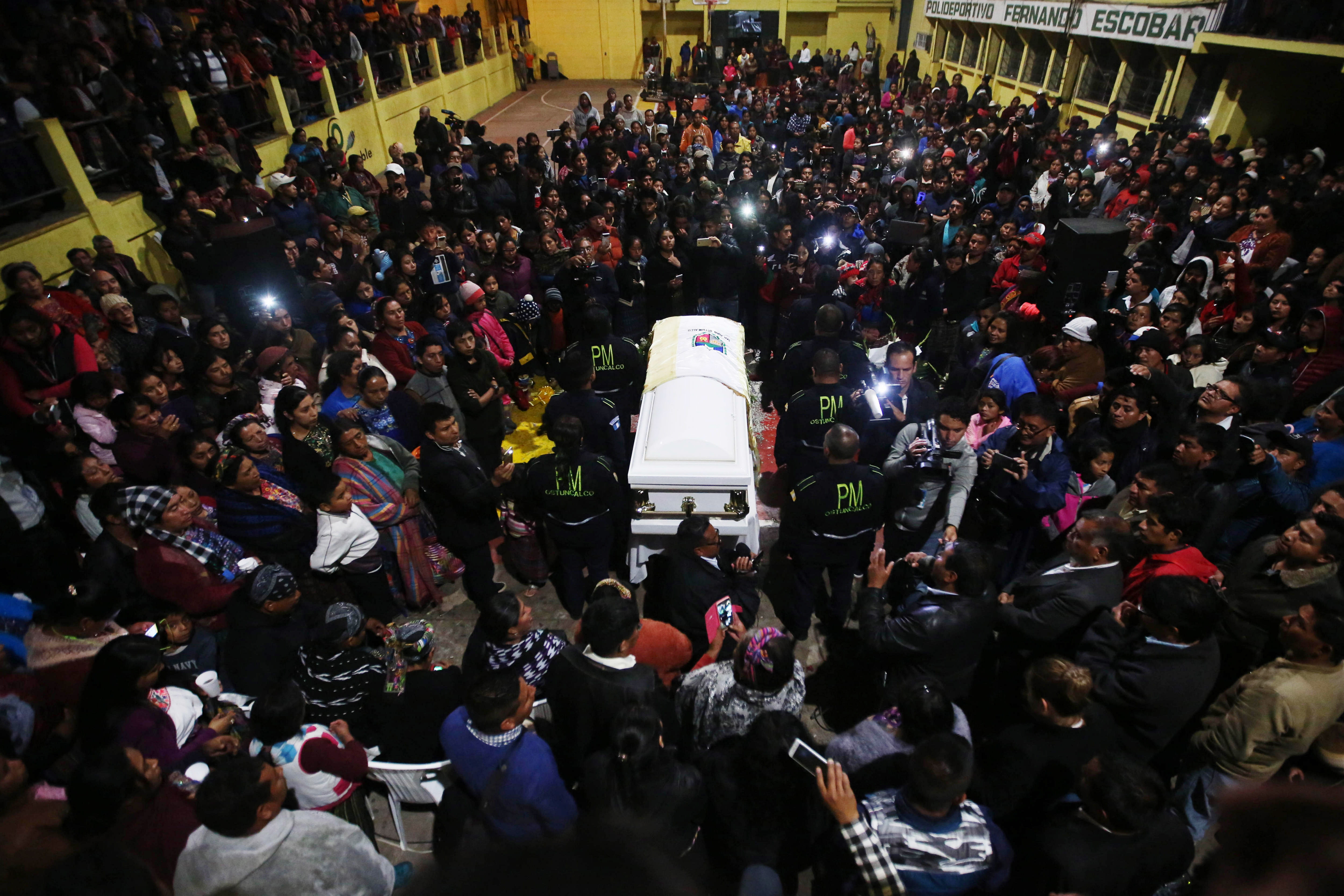 People accompany the coffin of the Guatemalan migrant Claudia Patricia Gomez Gonzalez during her wake, in San Juan Ostuncalco, Quetzaltenango, Guatemala, May 31, 2018. EPA-EFE/ESTEBAN BIBA
