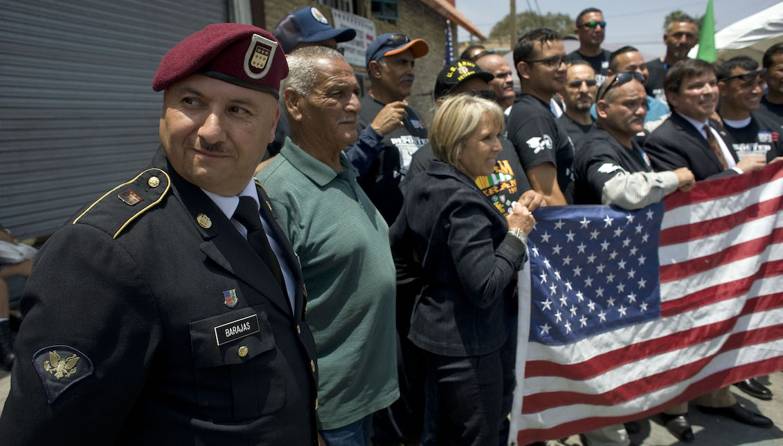 Veteran Hector Barajas (i) observes while some of his companions pose with some US congressmen during the visit of seven members of the US Congress to the House of Support for deported Veterans on Saturday, June 3, 2017, in Tijuana, Mexico. EFE/David Maung