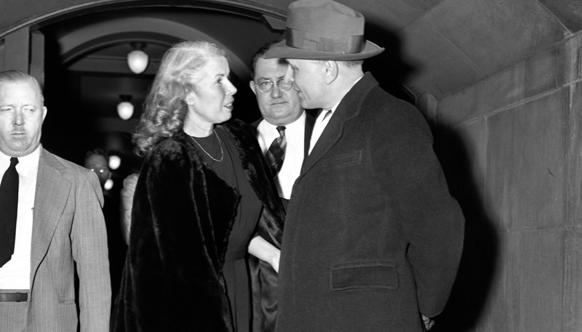 Mildred Gillars, the “Axis Sally” of wartime German propaganda broadcasts, confers with James Laughlin, her attorney, outside district court after testifying  that because she feared for her life she signed a “written oath of allegiance to German” the day after Pearl Harbor.    Bettmann Archive/Getty Images