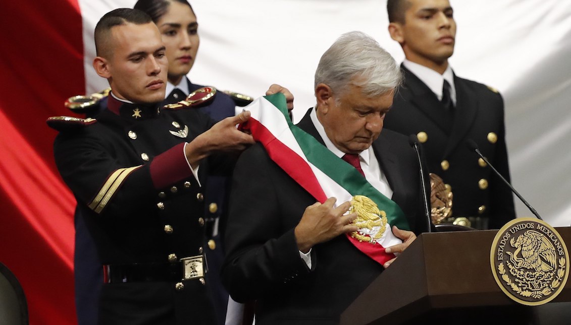 Leftist Andres Manuel Lopez Obrador (center) is adorned with the presidential sash after being sworn in as Mexico's new head of state at the headquarters of the Chamber of Deputies in Mexico City, Mexico. EFE/Jorge Núñez.