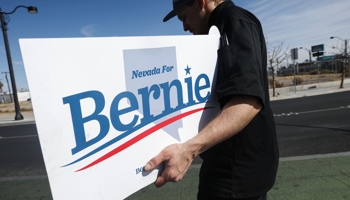 LAS VEGAS, NEVADA - FEBRUARY 18: A supporter of Democratic presidential candidate Sen. Bernie Sanders (I-VT) holds a 'Nevada For Bernie' sign on the final day of early voting for the upcoming Nevada Democratic presidential caucus on February 18, 2020 in Las Vegas, Nevada. (Photo by Mario Tama/Getty Images)