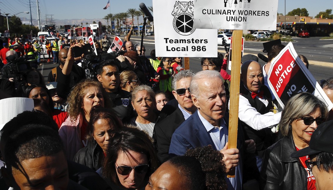 Democratic presidential candidate former Vice President Joe Biden walks on a picket line with members of the Culinary Workers Union Local 226 outside the Palms Casino in Las Vegas, on Feb. 19, 2020. (AP Photo/Patrick Semansky, File)