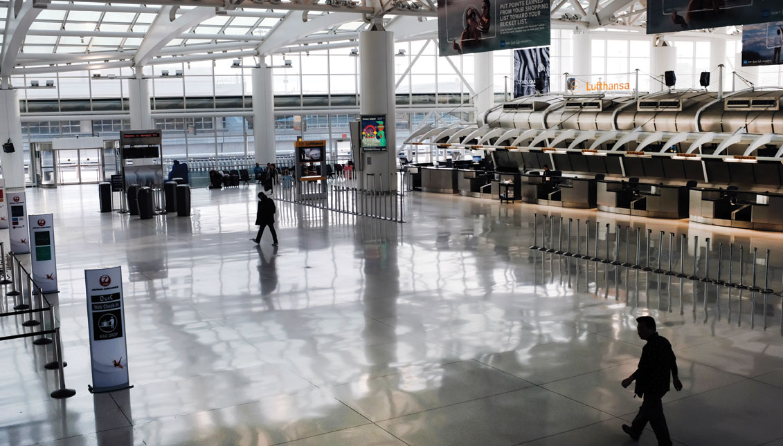 NEW YORK, NEW YORK - MARCH 07: People walk through a sparse international departure terminal at John F. Kennedy Airport (JFK) as concern over the coronavirus grows on March 7, 2020 in New York City. (Photo by Spencer Platt/Getty Images)