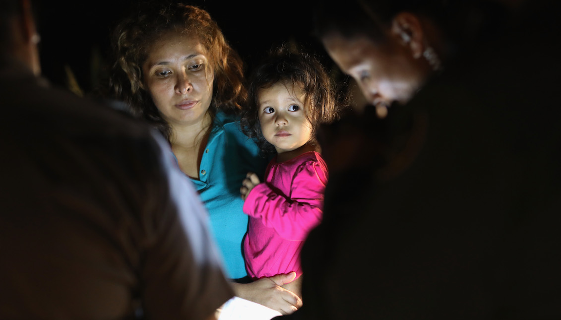 MCALLEN, TX - JUNE 12: Central American asylum seekers, including a Honduran girl, 2, and her mother, are taken into custody near the U.S.-Mexico border on June 12, 2018 in McAllen, Texas. (Photo by John Moore/Getty Images)