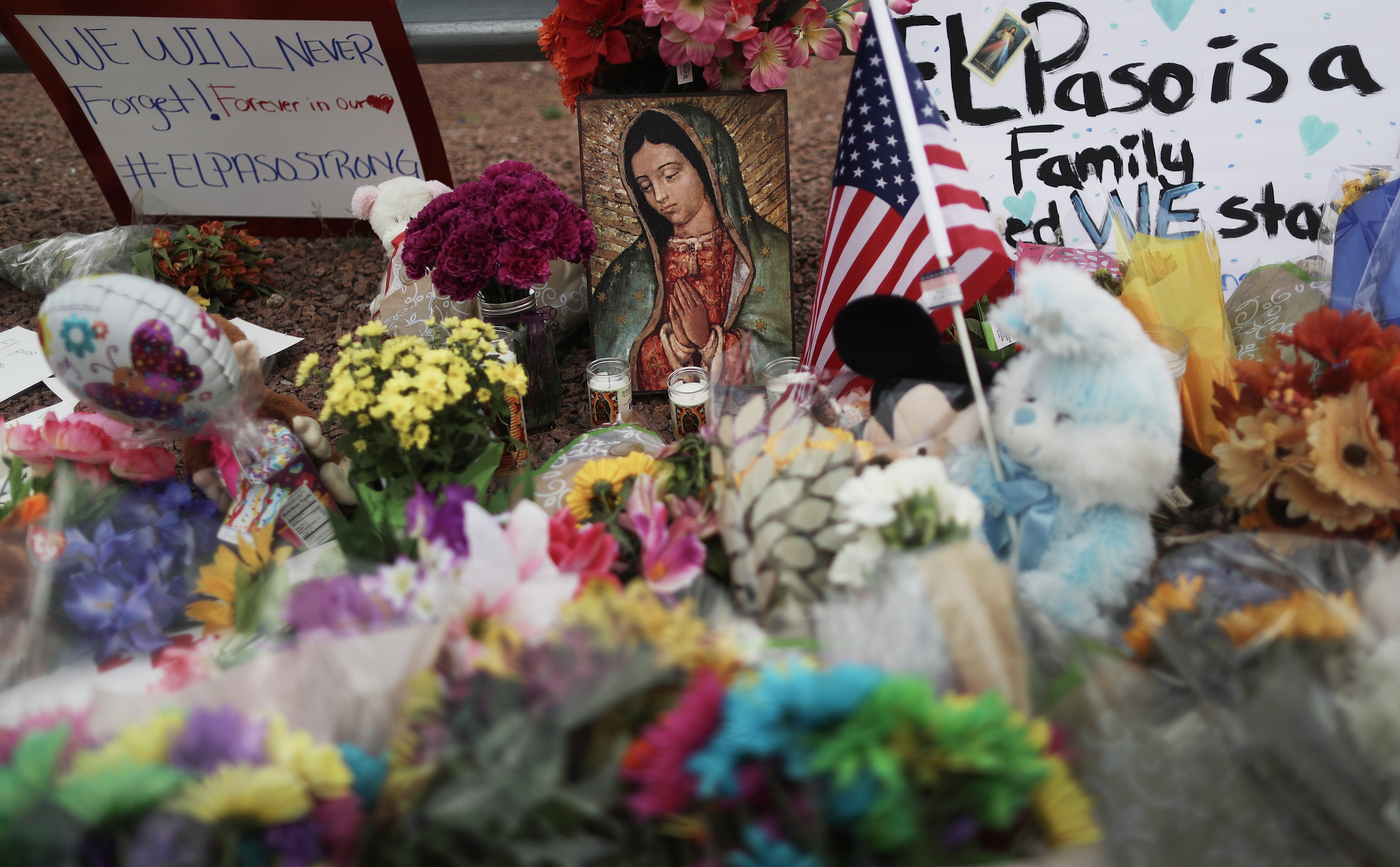 Flowers and mementos are seen at a makeshift memorial outside Walmart, near the scene of a mass shooting which left at least 20 people dead, on August 4, 2019 in El Paso, Texas. (Photo by Mario Tama/Getty Images)