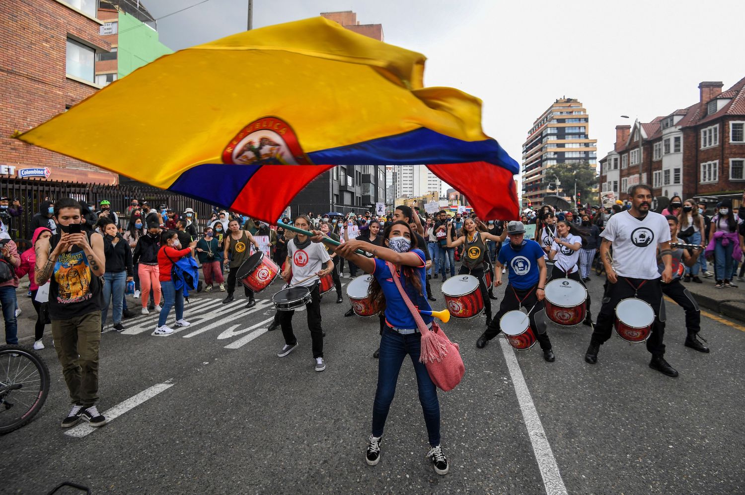 Caption:A woman waves a Colombian national flag during a protest against a tax reform proposed by Colombian President Ivan Duque's government in Bogota, on May 4, 2021. Photo: Juan Barreto/AFP via Getty Images. 