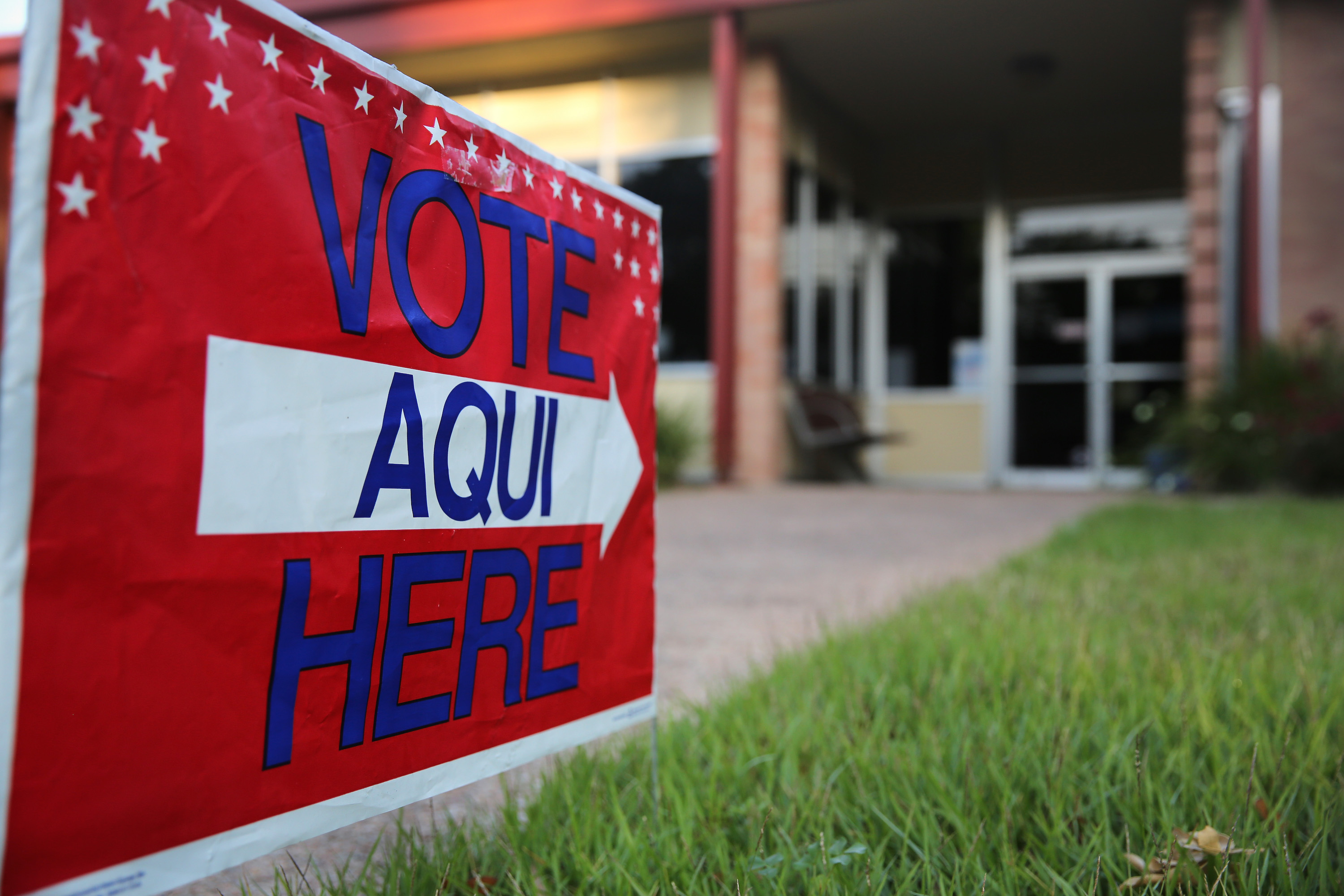A bilingual sign stands outside a polling center at public library ahead of local elections on April 28, 2013 in Austin, Texas. Early voting was due to begin Monday ahead of May 11 statewide county elections. The Democratic and Republican parties are vying for the Latino vote nationwide following President Obama's landslide victory among Hispanic voters in the 2012 election. Photo: John Moore/Getty Images.
