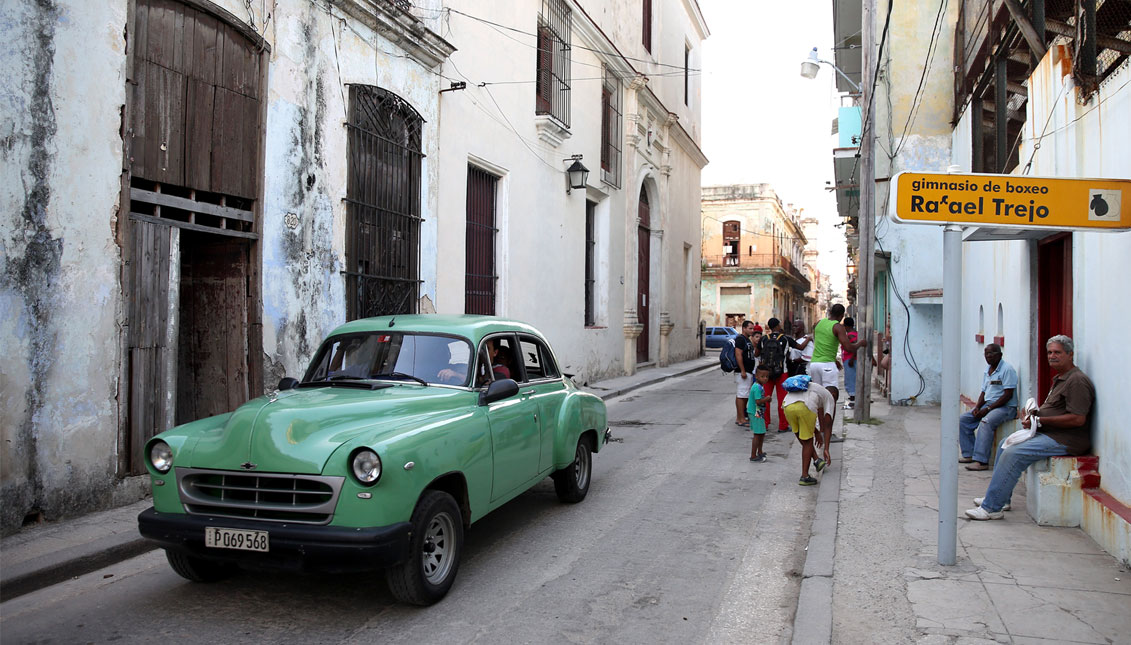 An old car drives past the front of the Rafael Trejo Boxing Gym on May 12, 2015 in Havana, Cuba. (Photo by Ezra Shaw/Getty Images)