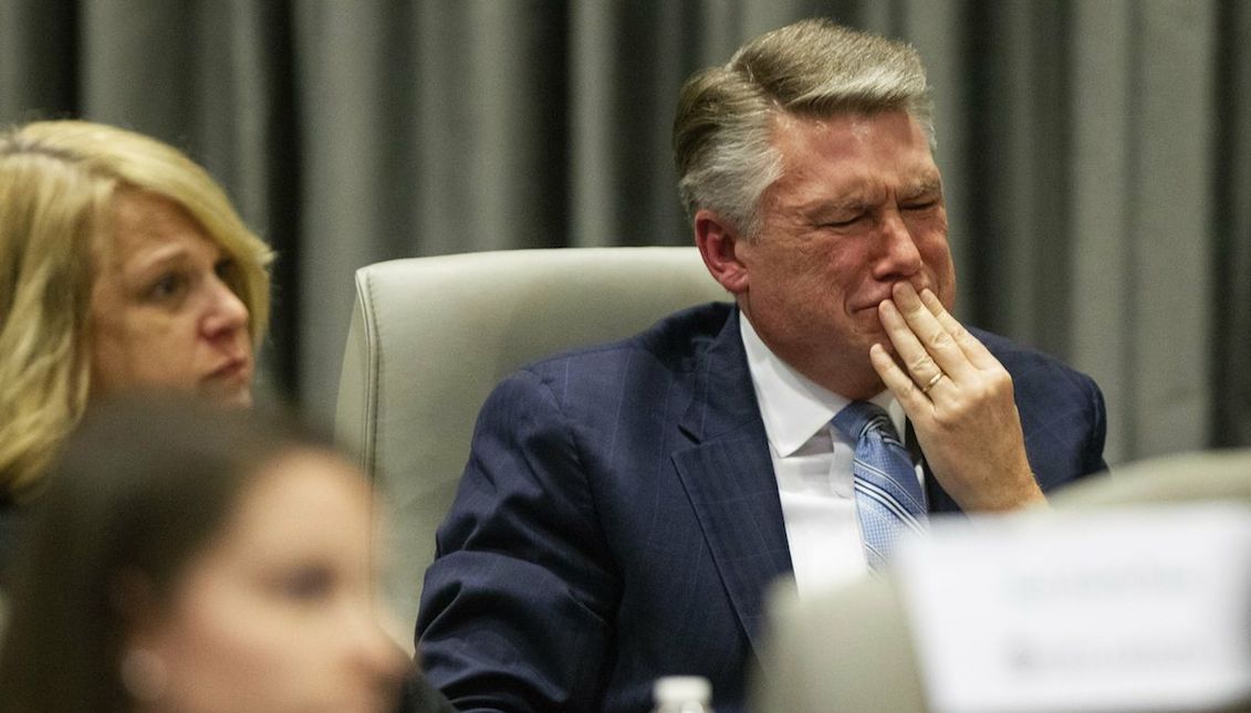 Mark Harris, the Republican candidate in North Carolina’s Ninth Congressional District race, fights back tears at the conclusion of his son John Harris’s testimony at a state board hearing on alleged election fraud. Travis Long/The News & Observer via AP