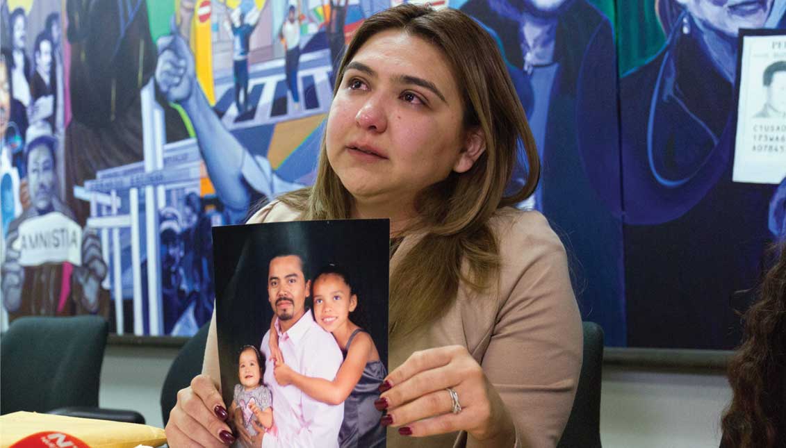 Ana Castillo shows a photo of her husband Marlon Castillo with two of her daughters during a press conference in Los Angeles, California. Marlon Castillo, 46, is one of the last undocumented immigrants arrested while doing paperwork to legalize his immigration status. EFE
