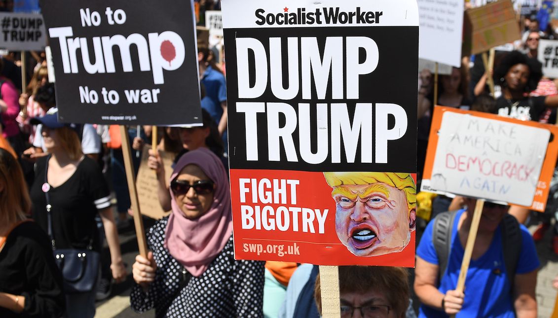 Demonstrators hold signs with messages against the president of the United States, Donald J. Trump, in London, United Kingdom on July 13, 2018. Trump’s visit to the United Kingdom raises mass protests in rejection of its policy on matters such as immigration and environment, and comments that his opponents describe as "racist" and "misogynistic". EFE / Andy Rain