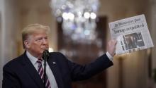 WASHINGTON, DC - FEBRUARY 06: U.S. President Donald Trump holds a copy of The Washington Post as he speaks in the East Room of the White House one day after the U.S. Senate acquitted on two articles of impeachment, ion February 6, 2020 in Washington, DC. (Photo by Drew Angerer/Getty Images)